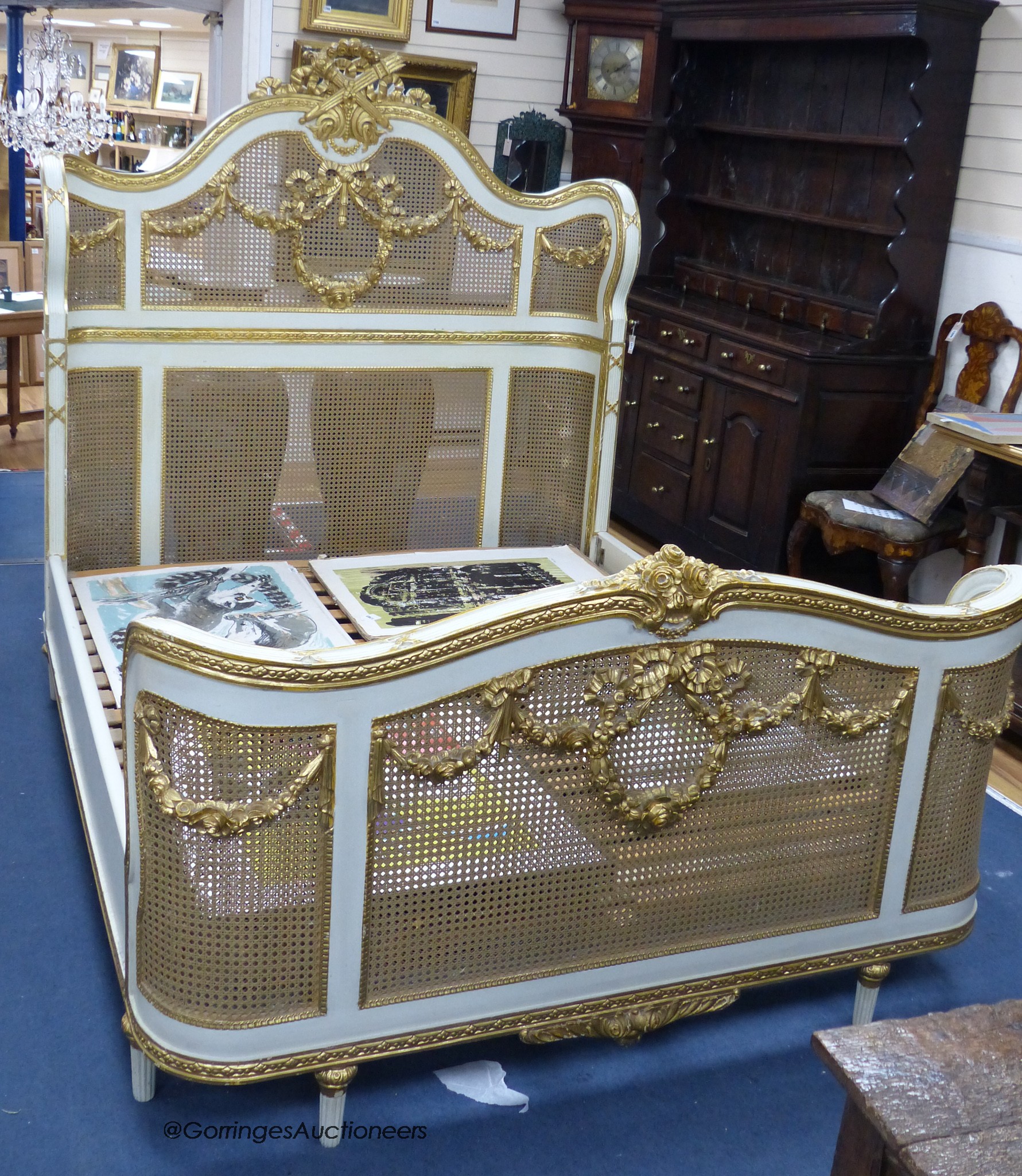 A Louis XVI style painted, giltwood and caned double bed frame, width 160cm, length 212cm, height 176cm
